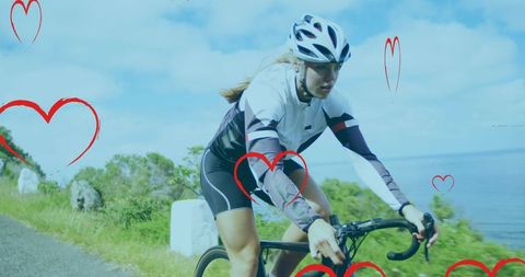 Female Cyclist on Scenic Coastal Route with Red Heart Overlay