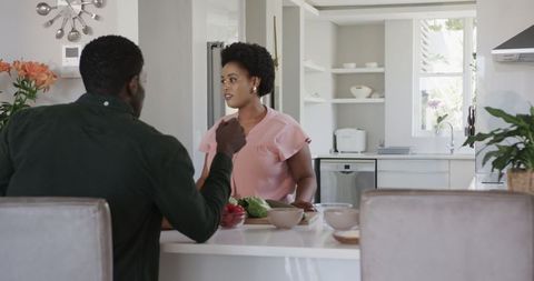 African American Friends Joyfully Chatting in Modern Kitchen
