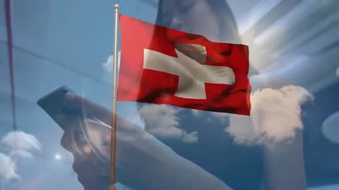Swiss Flag Waving with Person on Smartphone against Vibrant Sky