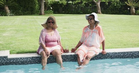 Senior Women Relaxing by Poolside Enjoying Summer Leisure