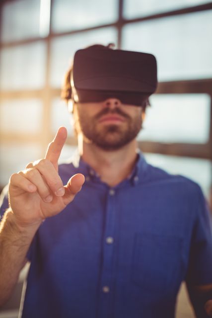 Business executive experiencing virtual reality technology in an office setting. Ideal for use in articles or advertisements related to corporate technology innovations, virtual reality applications in business, and modern office environments.