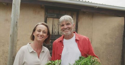 Senior Couple Enjoying Gardening with Fresh Vegetables