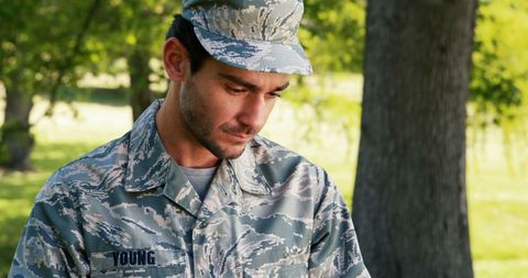 Soldier Using Digital Tablet Outdoors in Park