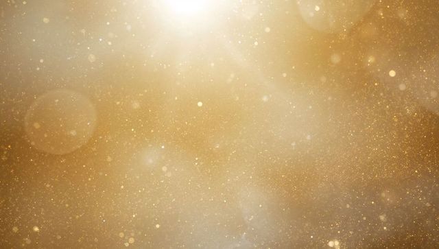 Shimmering Golden Particles with Ethereal Glow Background