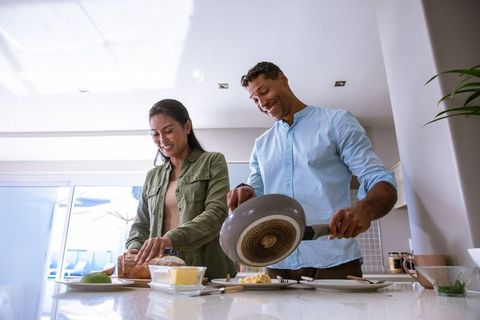 Joyful Couple Making Breakfast in Modern Kitchen