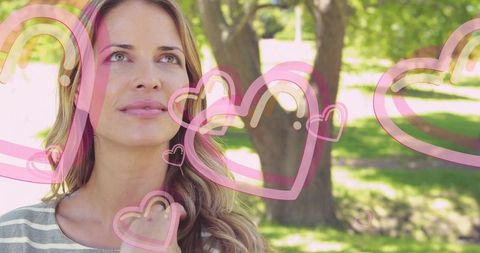 Woman in park daydreaming in sweet romantic bliss