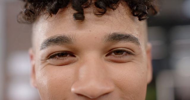 Close-Up of Young Person with Curly Hair and Soft Smile - Download Free Stock Images Pikwizard.com