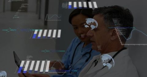 Doctors Analyzing Digital Data on Tablet in Hospital Corridor