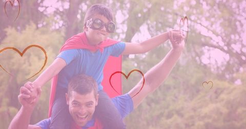 Father and Son Playing with Superhero Theme Outdoors