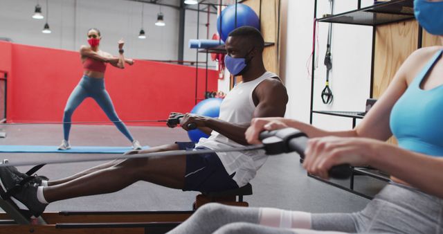 People Working Out in Fitness Center, Wearing Face Masks for Safety - Download Free Stock Images Pikwizard.com