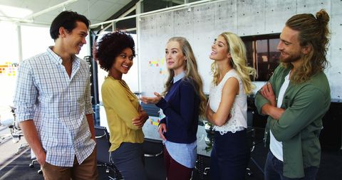 Diverse professionals discussing projects in modern office