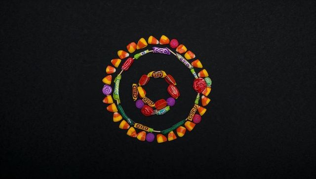 Colorful concentric candy circles on dark tabletop