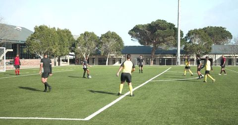 Youth Soccer Team Practicing On Field Under Clear Sky