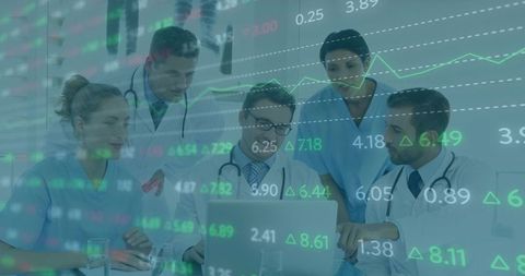 Medical Team Analyzing Data Trends on Laptop in Modern Clinic