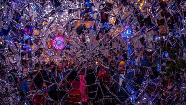 Kaleidoscopic shattered mirror revealing formal gala guests through fragmented reflections