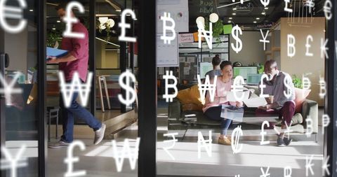 Diverse team collaborating in modern office with currency symbols overlay