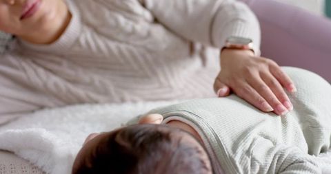 Mother bonding with baby daughter in cozy home setting