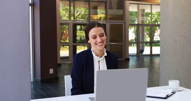 Smiling Businesswoman Using Laptop in Modern Office Lobby - Download Free Stock Images Pikwizard.com