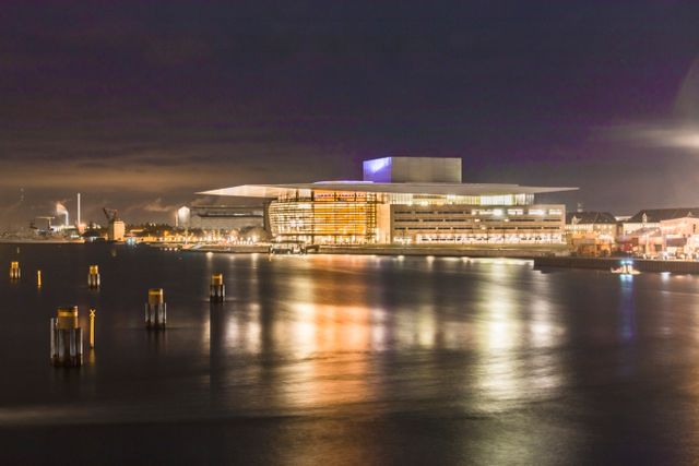 Modern Opera House Illuminated at Night with Reflections on Water - Download Free Stock Images Pikwizard.com