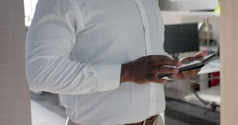 Businessman Analyzing Data on Tablet at Office