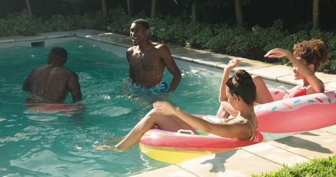 Diverse Friends Enjoying Summer Day in Backyard Pool