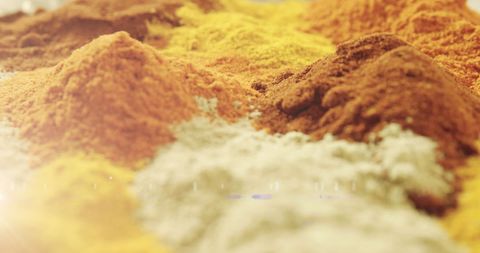 Colorful spice mounds with golden light flare