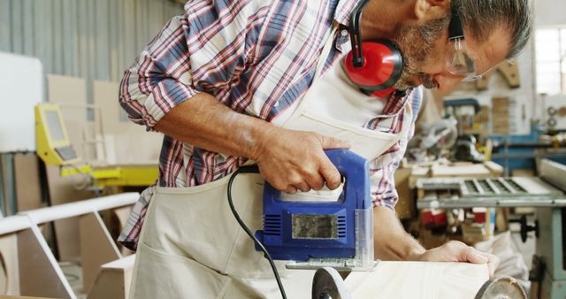 Carpenter Using Electric Jigsaw in Workshop - Download Free Stock Images Pikwizard.com