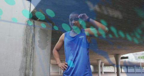 Athletic man in urban underpass wearing fitness technology