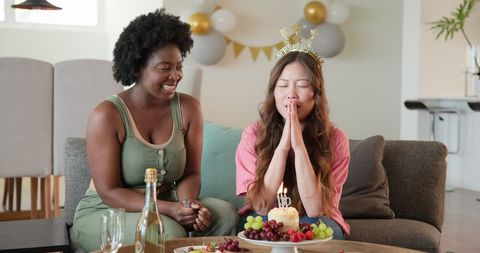 Joyful Friends Celebrating Birthday Party with Cake and Candles