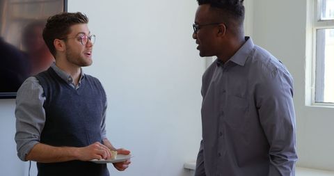 Colleagues in Casual Office Setting Having Engaging Conversation