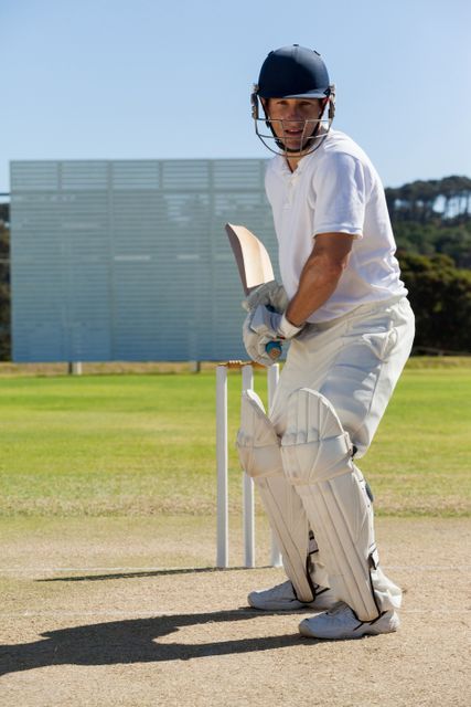 Focused Cricket Player Batting on Sunny Day - Download Free Stock Photos Pikwizard.com
