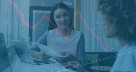 Businesswomen Analyzing Financial Charts in Corporate Office