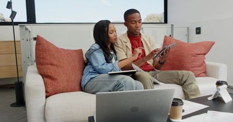 Coworkers collaborating in modern office lounge