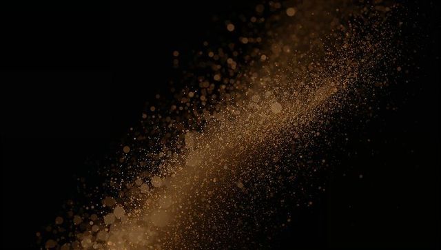 Shimmering Golden Particle Cloud Against Black Background