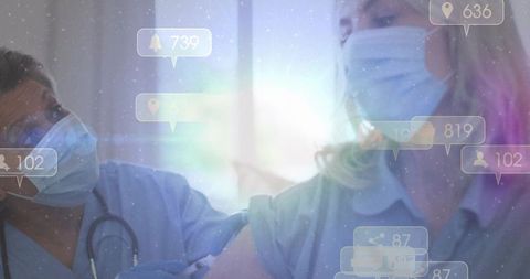 Nurse administering vaccine to patient wearing mask and gloves with notification overlay