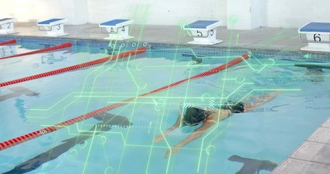Competitive swimmer cutting lap with futuristic hud overlay in indoor pool for performance