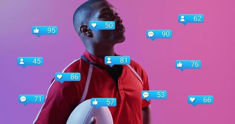 Athlete in red jersey holding football receiving social media engagement icons on pink gradient back