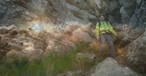 Adventurous Hiker Navigating Rocky Gorge with Determination