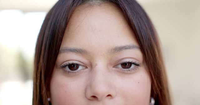 Close-up of a young woman's eyes and forehead, conveying natural beauty and simplicity. This image can be used in a variety of contexts such as skincare product promotions, mental health campaigns, personal blog posts, and more to emphasize purity, focus, and introspection.