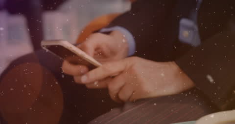 Businessman Using Smartphone with Digital Snowfall Effect