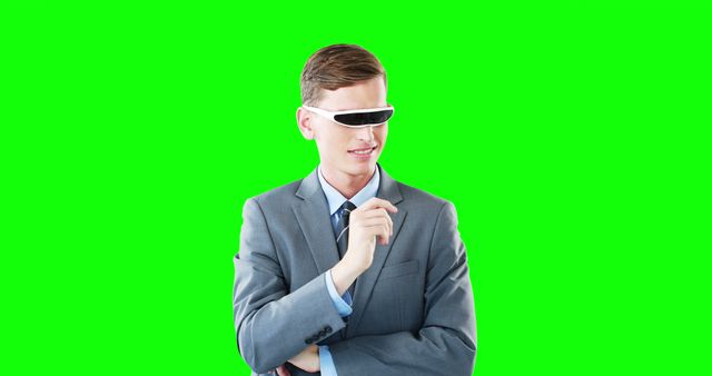 Businessman in suit is wearing futuristic VR glasses, green background enhances the modern and tech-savvy theme. Perfect for use in technology articles, business presentations, and advertisements related to virtual reality and corporate innovation.