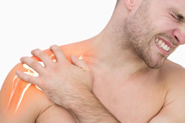 This image is useful for medical blogs, healthcare websites, pain relief product advertisements, articles on injury recovery, and for illustrating human anatomy. It shows a man experiencing significant pain in his shoulder, with an area highlighted to indicate the source of the discomfort. Perfect for visual contexts discussing muscle injuries and treatments.