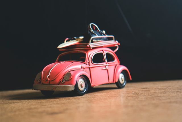 Vintage Red Toy Car with Retro Surfboard on Roof - Download Free Stock Photos Pikwizard.com