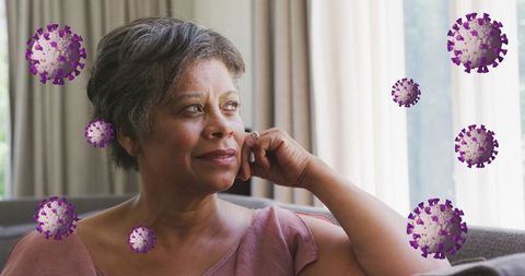 Senior woman contemplating during pandemic with virus illustration