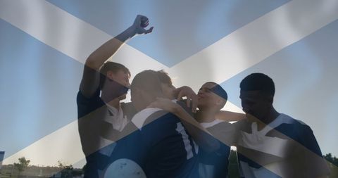 Triumphant Rugby Team Celebrating with Scottish Flag Overlay