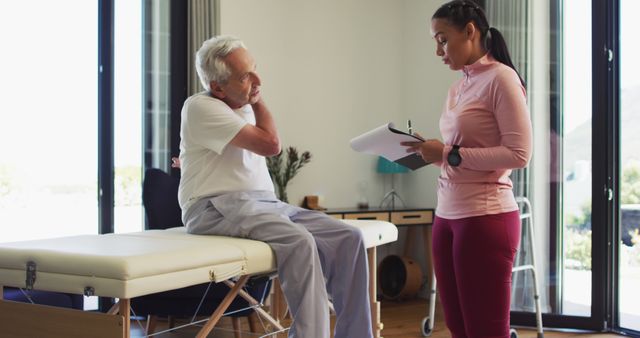 Senior Man Consulting with Female Physiotherapist at Modern Clinic - Download Free Stock Images Pikwizard.com