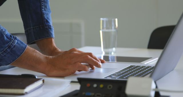 Person in Denim Shirt Working on Laptop in Office Workspace - Download Free Stock Images Pikwizard.com