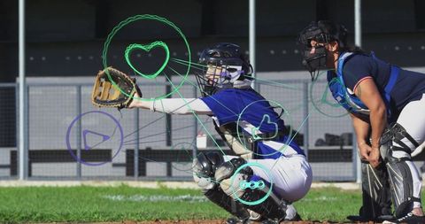 Baseball catcher awaiting pitch with umpire during game