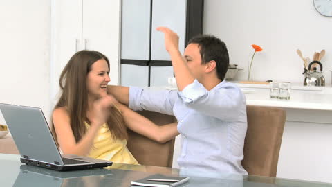 Happy Couple Enjoying Videos Together at Home