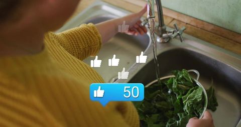 Woman rinsing leafy greens at kitchen sink with social likes overlay and blue like counter